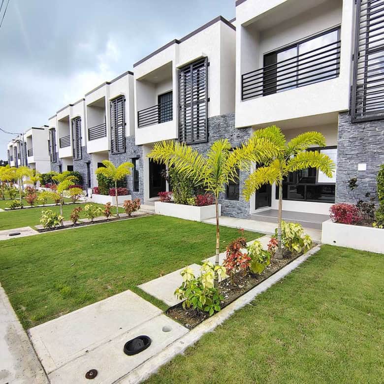 Modern townhouses with lush landscaping at Ella Vista Gardens, Cornerstone.