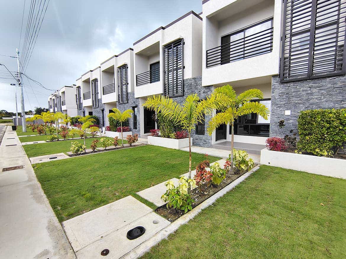 Modern townhouses with lush landscaping at Ella Vista Gardens, Cornerstone.