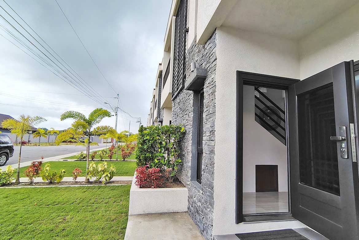 Modern apartment entrance with garden view at Ella Vista Gardens 8B.