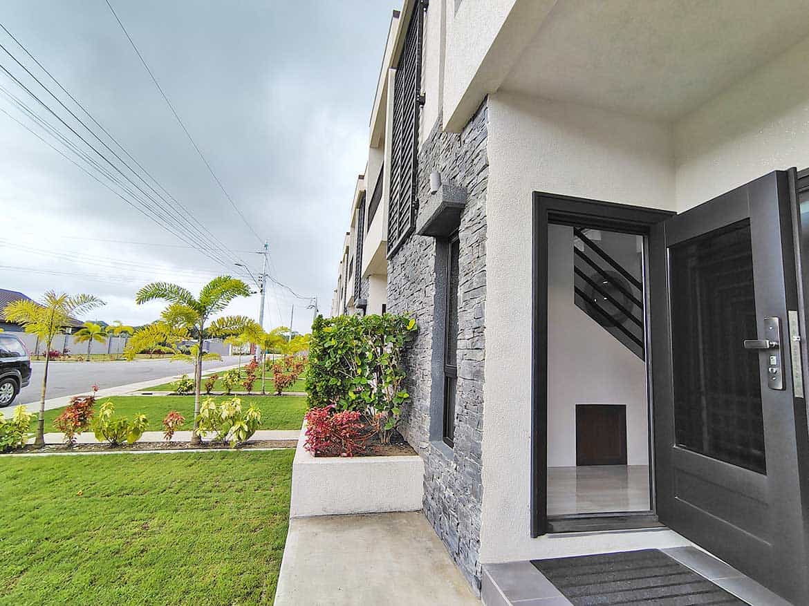 Cornerstone™ Ella Vista Gardens 8B Modern apartment entrance with garden view at Ella Vista Gardens 8B.