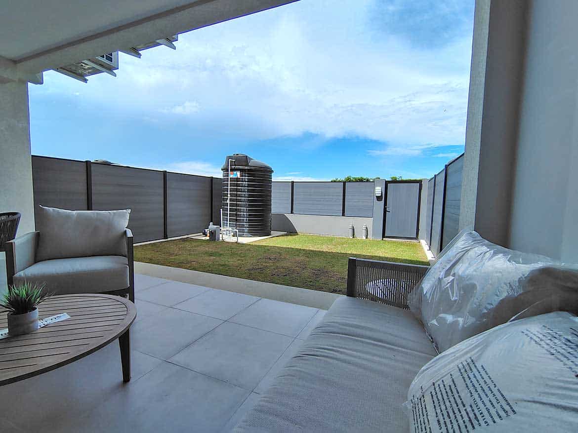 Cornerstone™ Ella Vista Gardens 8B Modern outdoor patio with view of backyard and sky at Ella Vista Gardens 8B.