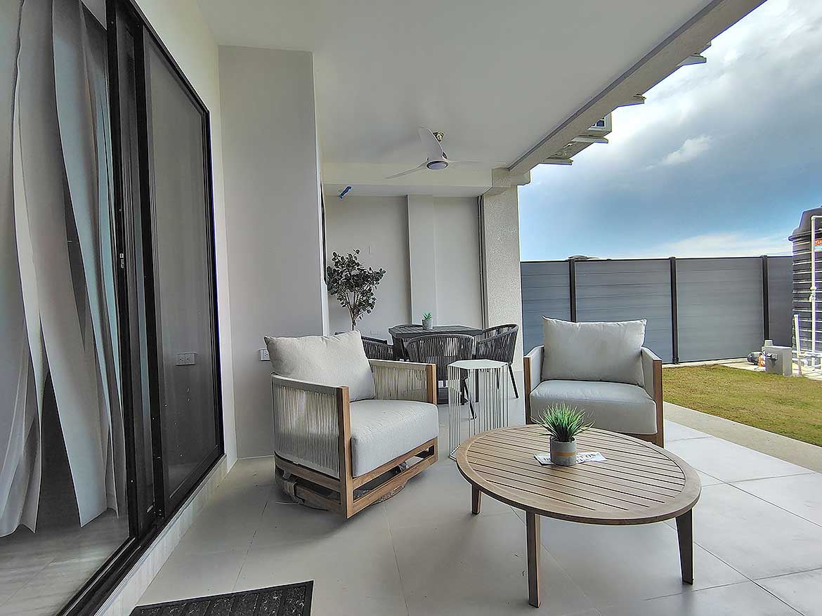 Cornerstone™ Ella Vista Gardens Balcony Modern balcony with outdoor seating and city view at Ella Vista Gardens.