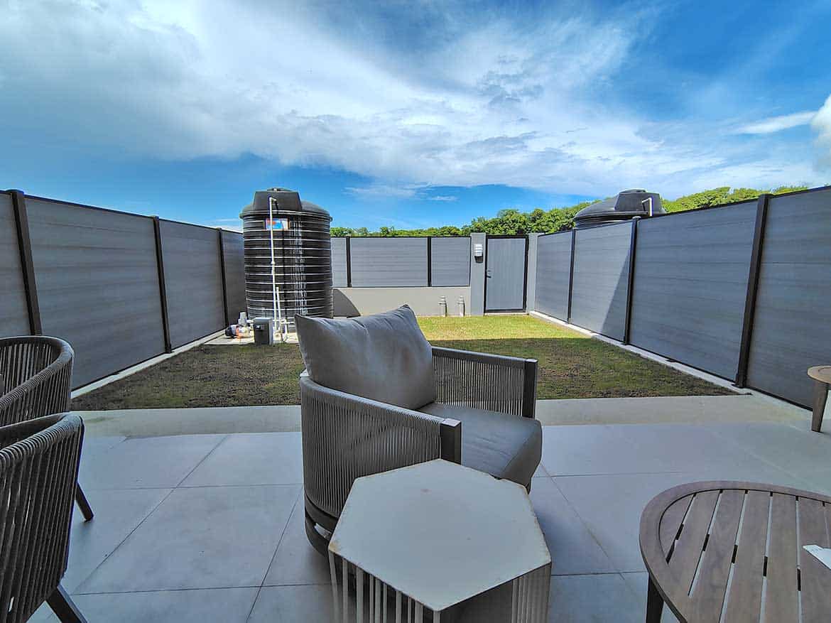 Ella Vista Gardens Outdoor Space Modern outdoor patio with seating and water tanks at Ella Vista Gardens.