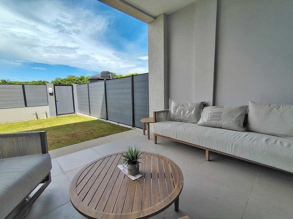 Cornerstone™ Ella Vista Gardens Balcony Modern balcony with outdoor seating and garden view at Ella Vista Gardens.
