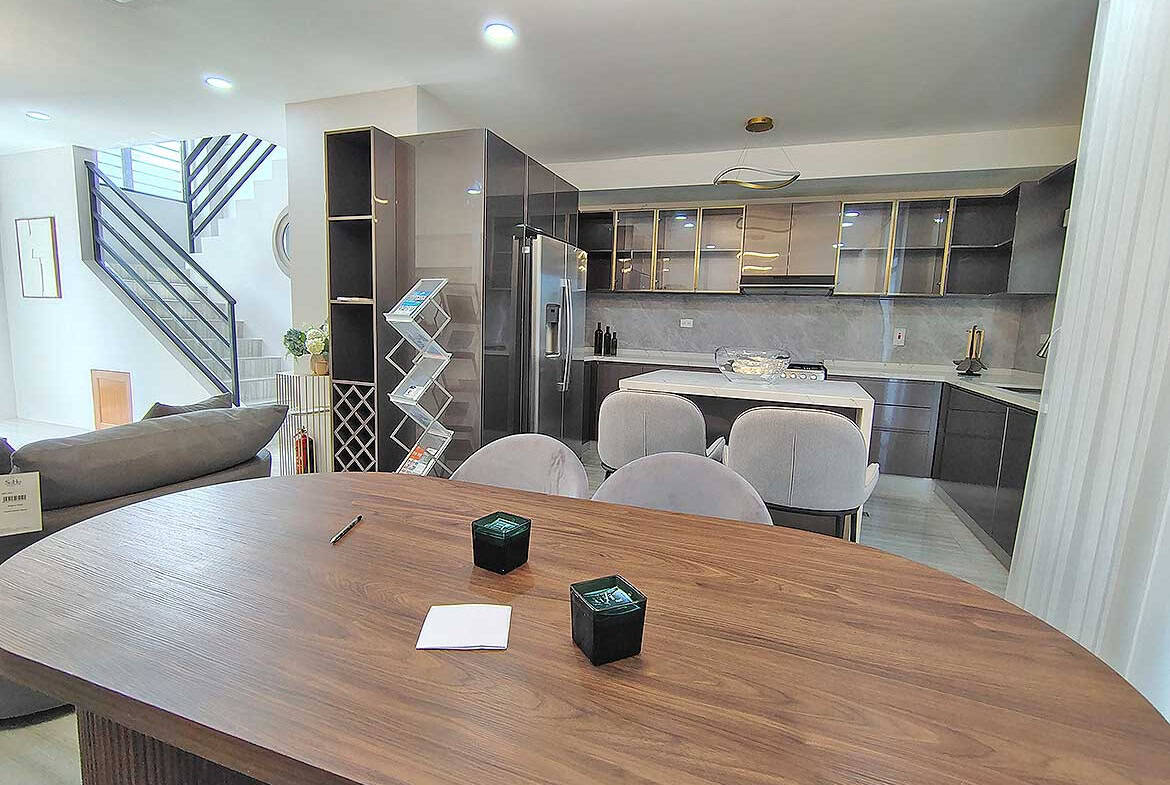 Contemporary kitchen with dining table and seating in Ella Vista Gardens.