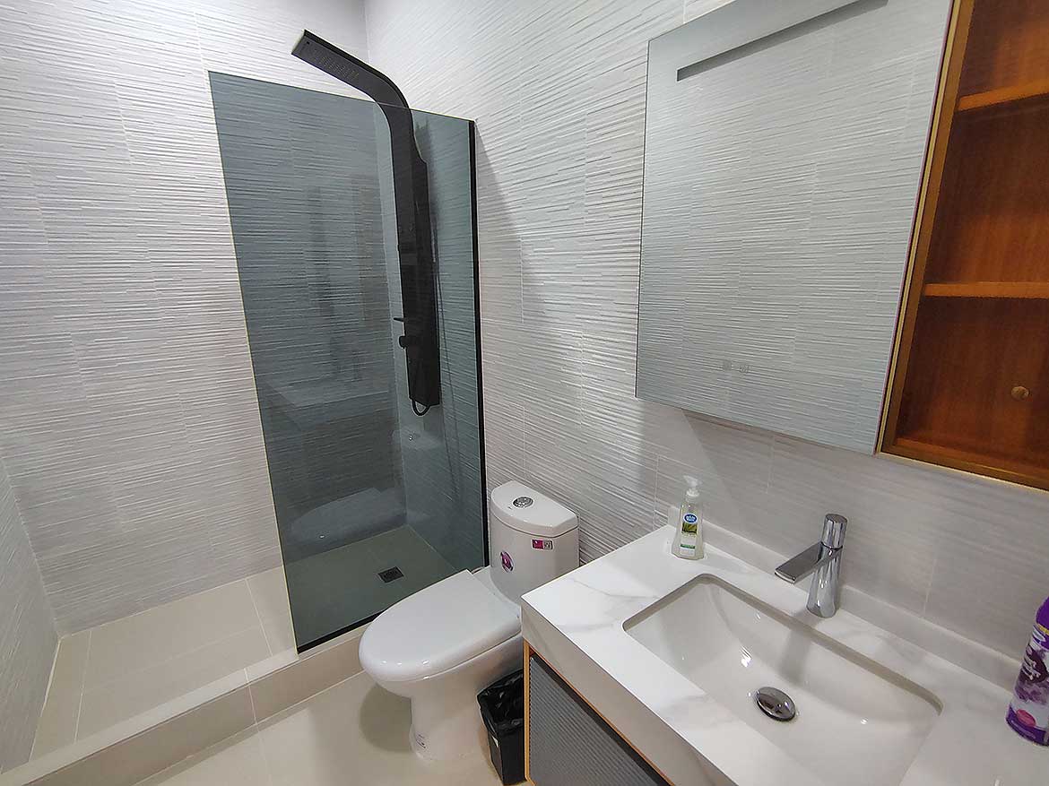 Modern Bathroom at Ella Vista Gardens Contemporary bathroom with walk-in shower, toilet, and vanity at Ella Vista Gardens.