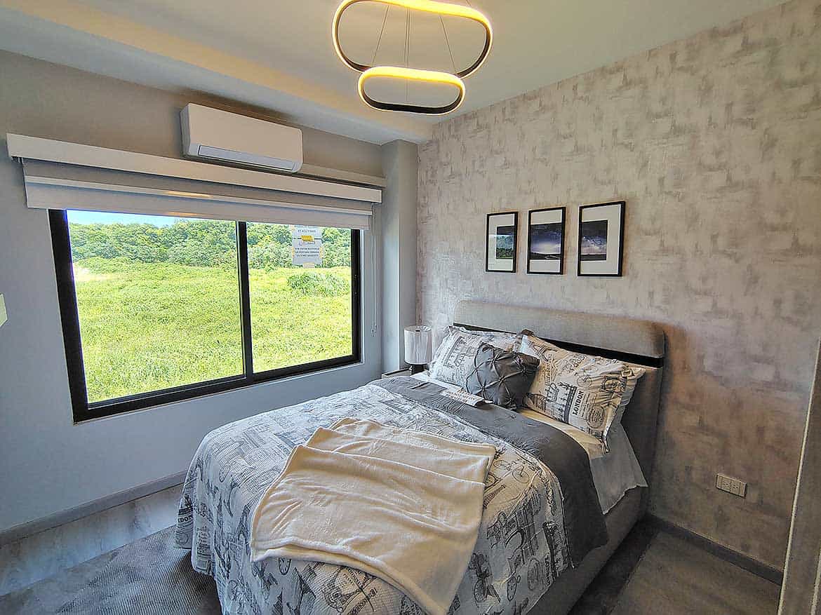 Modern Bedroom at Ella Vista Gardens Contemporary bedroom with large window and stylish decor at Ella Vista Gardens.
