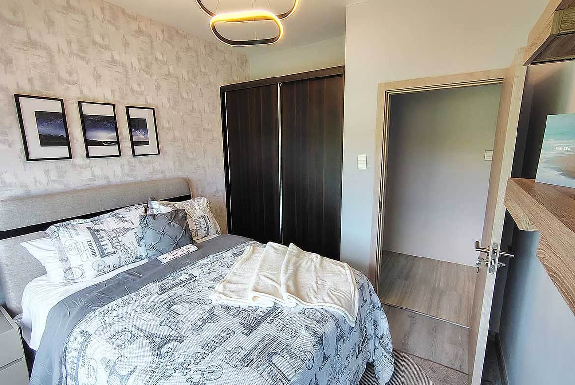 Contemporary bedroom with stylish decor and cozy bedding at Ella Vista Gardens.