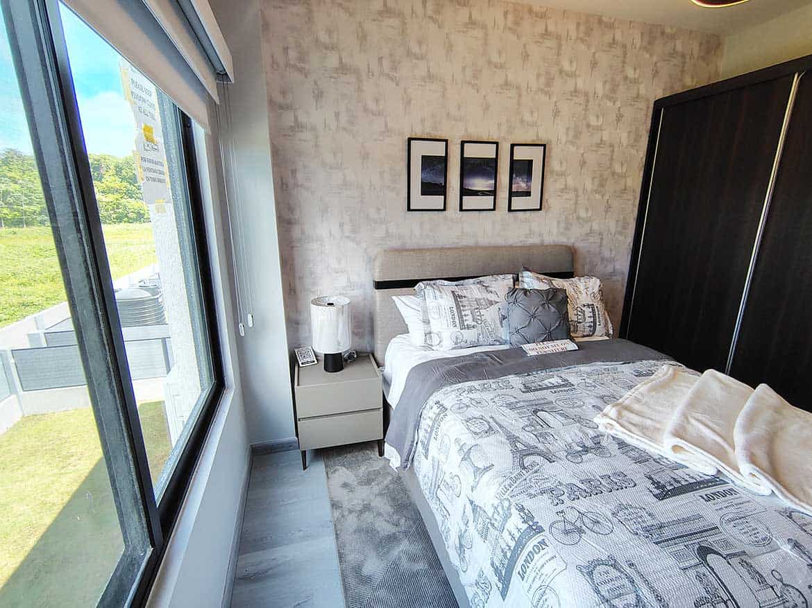 Modern Bedroom at Ella Vista Gardens Bright modern bedroom with large window and stylish decor at Ella Vista Gardens.