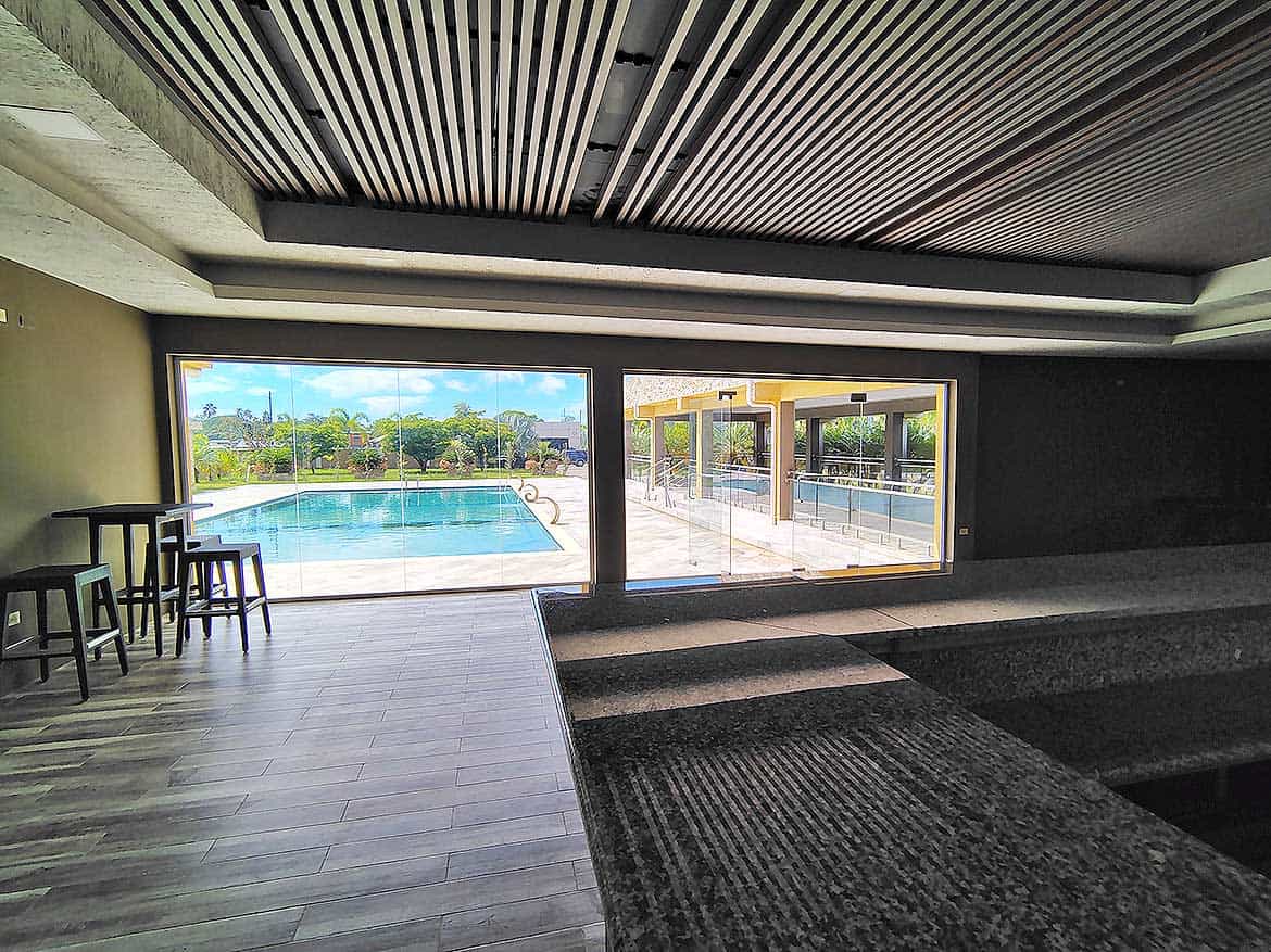 Ella Vista Gardens Pool Area Modern pool area at Ella Vista Gardens with seating and scenic view.