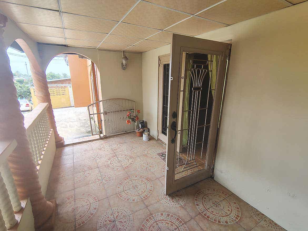 Cornerstone™ Entrance in Arima Cornerstone- Front porch of Cornerstone™ property in Arima with open door and tiled floor.