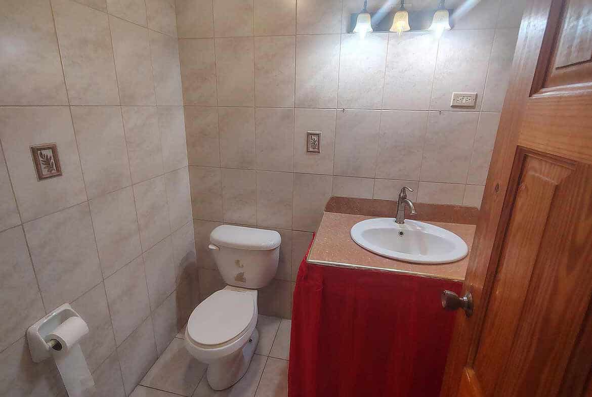 Cornerstone- Clean bathroom with toilet and sink in Cleaver Road, Arima.