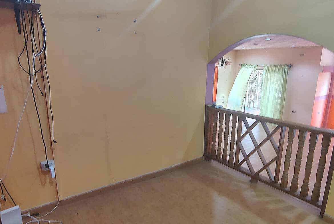 Cornerstone- Spacious interior with yellow walls and wooden railing at Cornerstone™ property.
