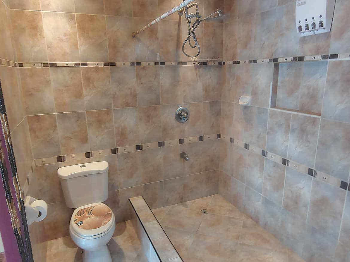 Cornerstone™ Bathroom Shower Area Cornerstone- Bathroom shower with tiled walls and toilet at Cornerstone™.