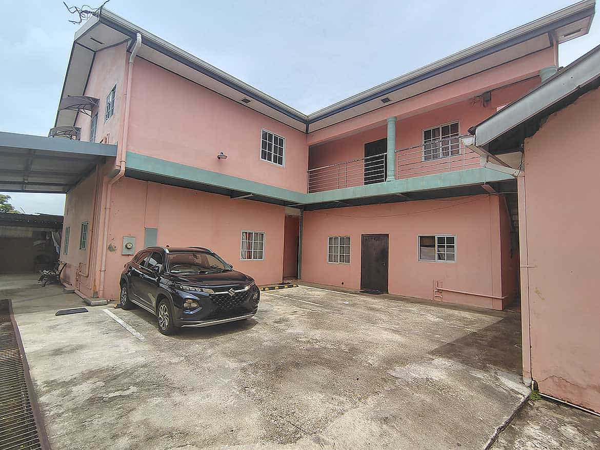 Cornerstone™ Residential Building in Arima Cornerstone- Pink residential building with parking area in Arima, Trinidad and Tobago.