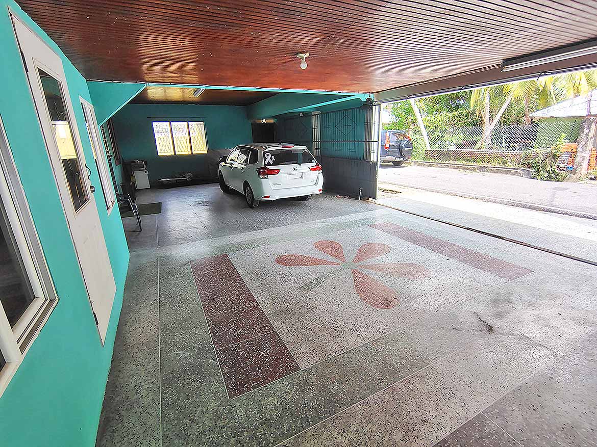 Covered Parking Area at Alexander Street Covered parking space with a white car and decorative floor design.