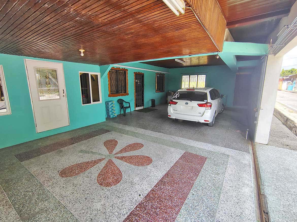 Cornerstone™ Parking Area Covered parking space with a white car and turquoise building exterior.