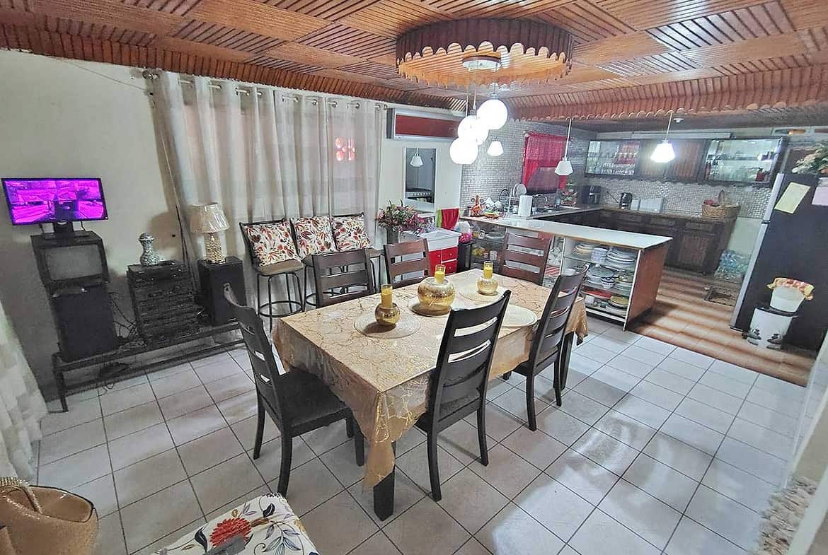 Spacious dining room with wooden ceiling and modern decor.