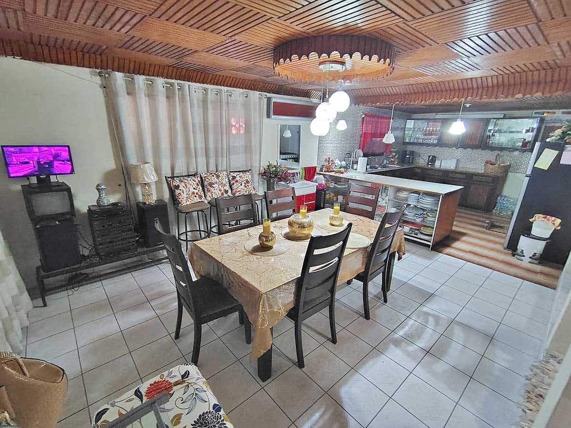 Cornerstone™ Dining Area Spacious dining room with wooden ceiling and modern decor.