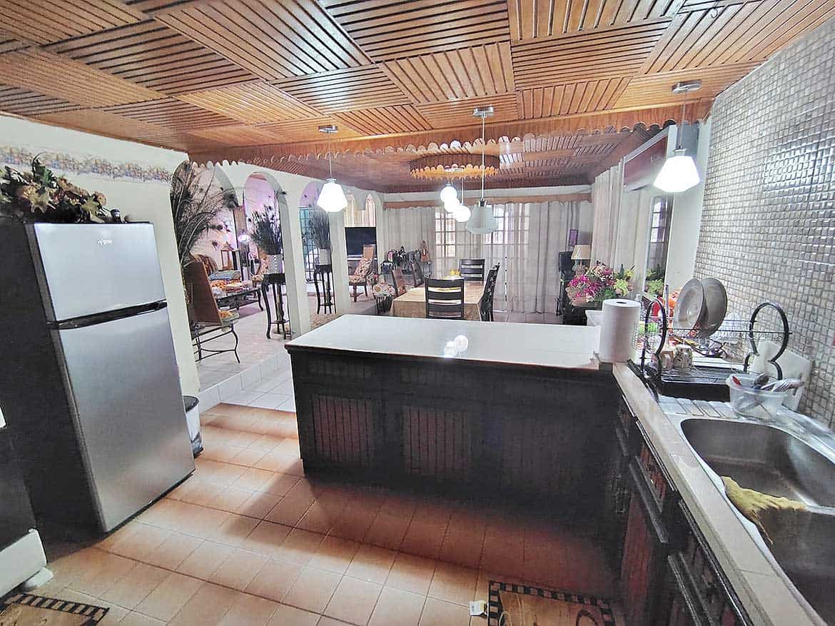 Cornerstone™ Kitchen and Dining Area Spacious kitchen and dining area with wooden ceiling and modern appliances.