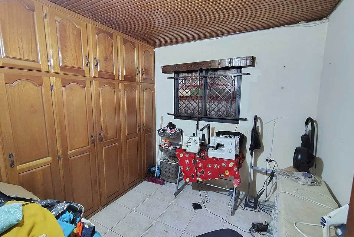 Cozy room with wooden cabinets and small appliances on a table.