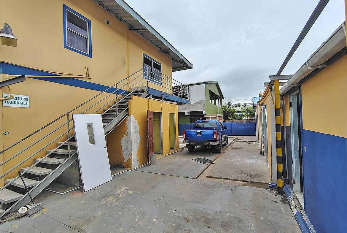 Cornerstone- Cornerstone™ building with parking area and blue truck on Johnny King Road.