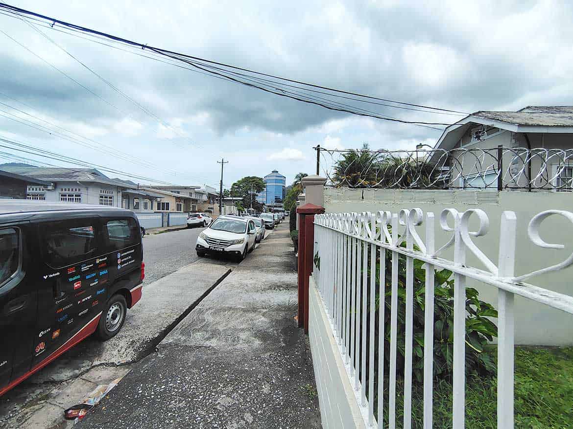 Carlos Street Woodbrook Residential Area Cornerstone- Residential street view in Woodbrook with parked cars and houses.