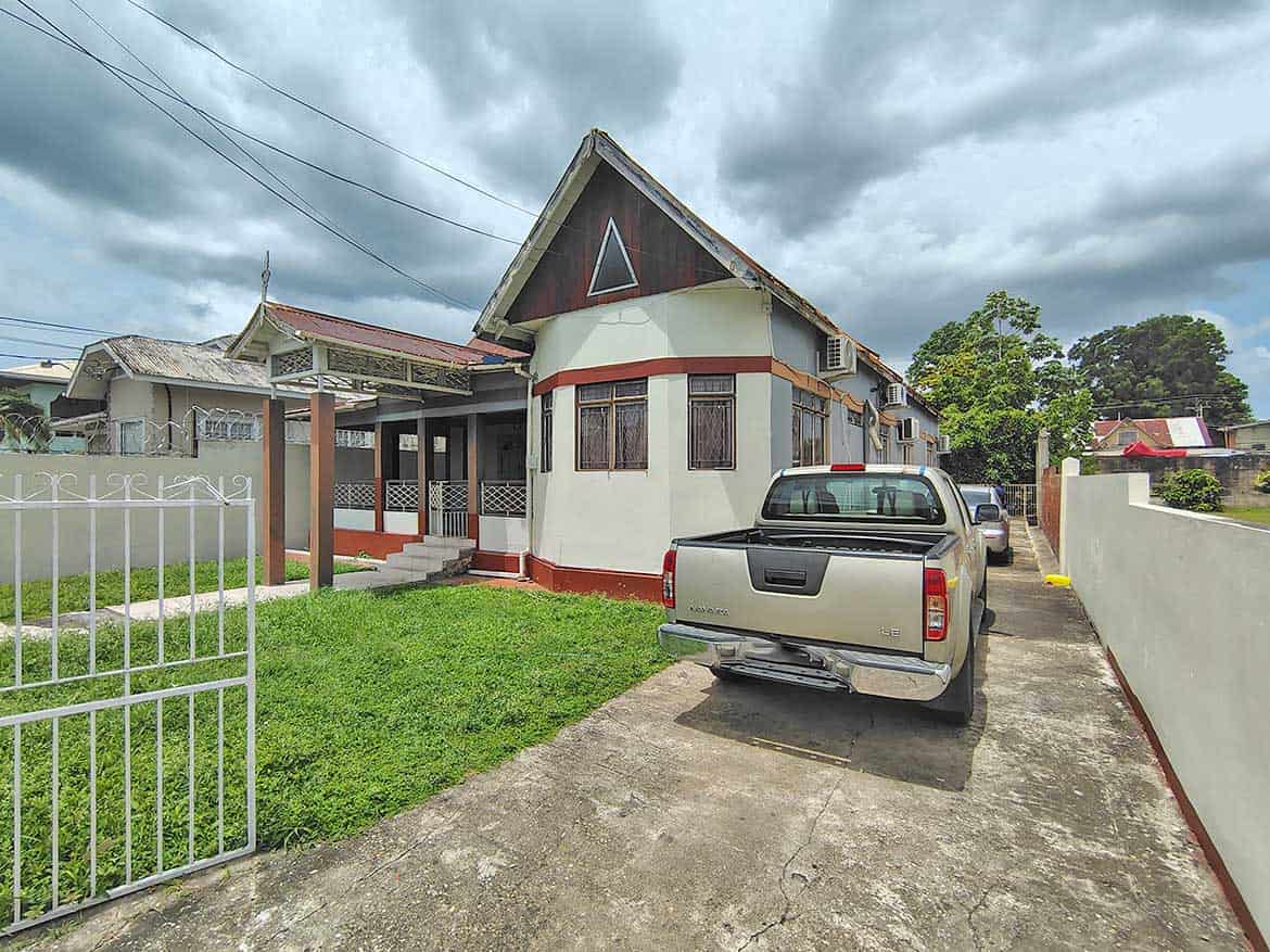 Cornerstone™ Property on Carlos Street Cornerstone- Residential house on Carlos Street with parked truck and cloudy sky.