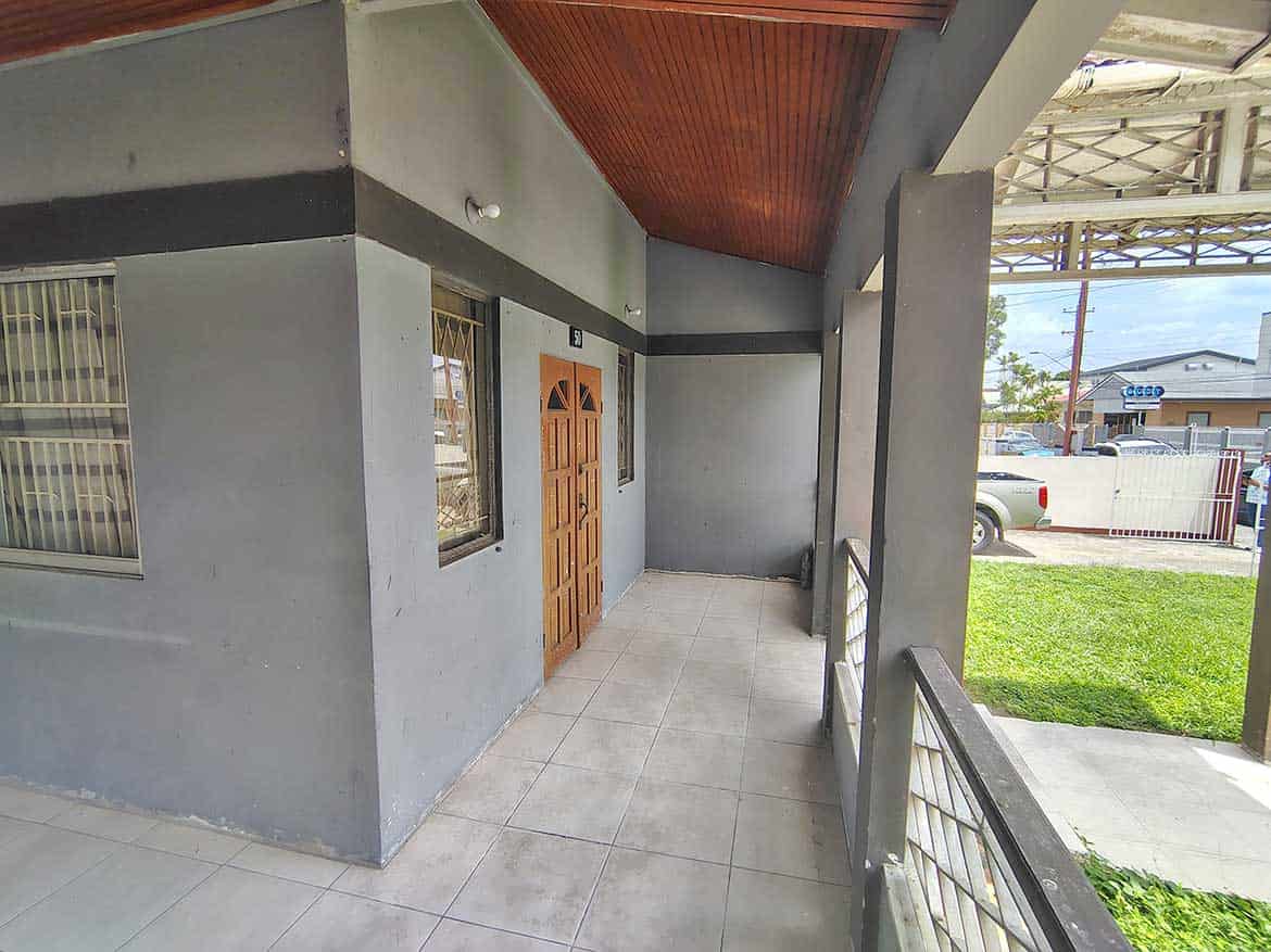 Cornerstone™ Commercial Building Entrance Cornerstone- Modern commercial building entrance with wooden door and tiled porch.