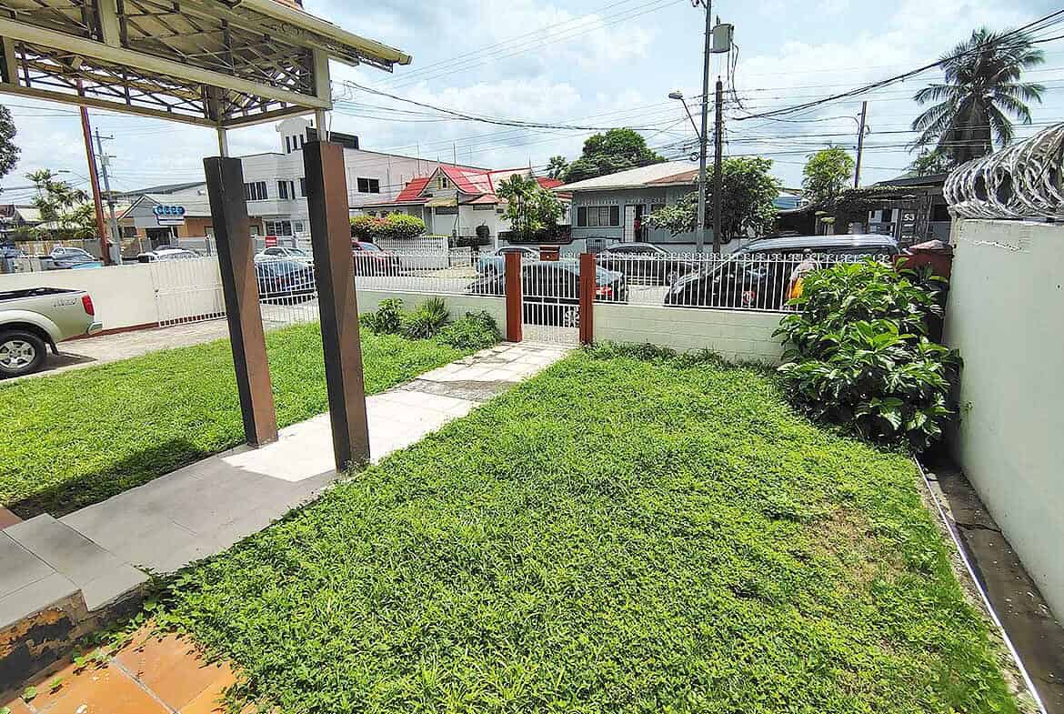Cornerstone- Residential entrance with pathway and greenery in Woodbrook.