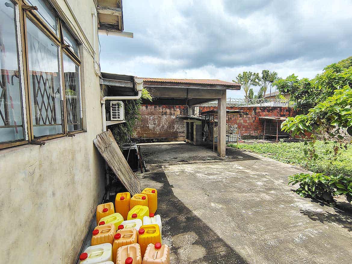 Cornerstone™ Residential Area in Woodbrook Cornerstone- Residential backyard with water containers and garden in Woodbrook, Trinidad.