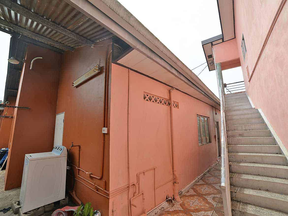 Cornerstone™ Residential Building in Arima Cornerstone- Residential building on Cleaver Road, Arima with pink exterior walls and outdoor staircase.