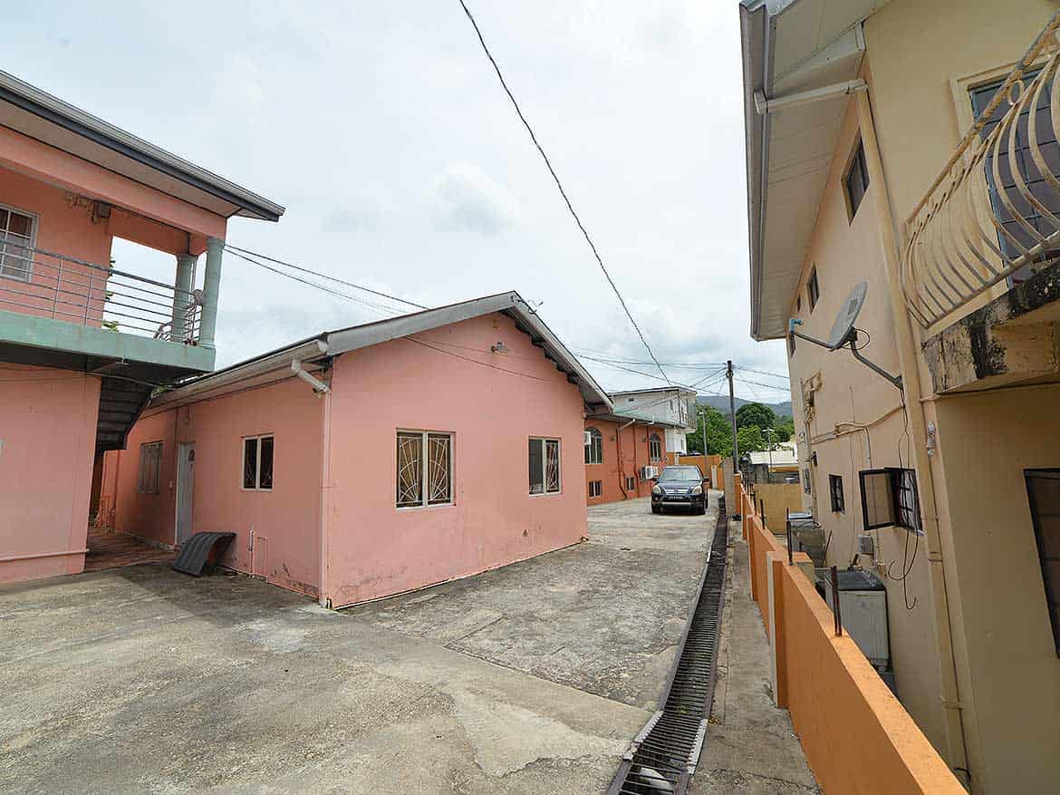 Cornerstone™ Residential Area in Arima Cornerstone- Residential buildings on Cleaver Road, Arima, with parking and utility lines.