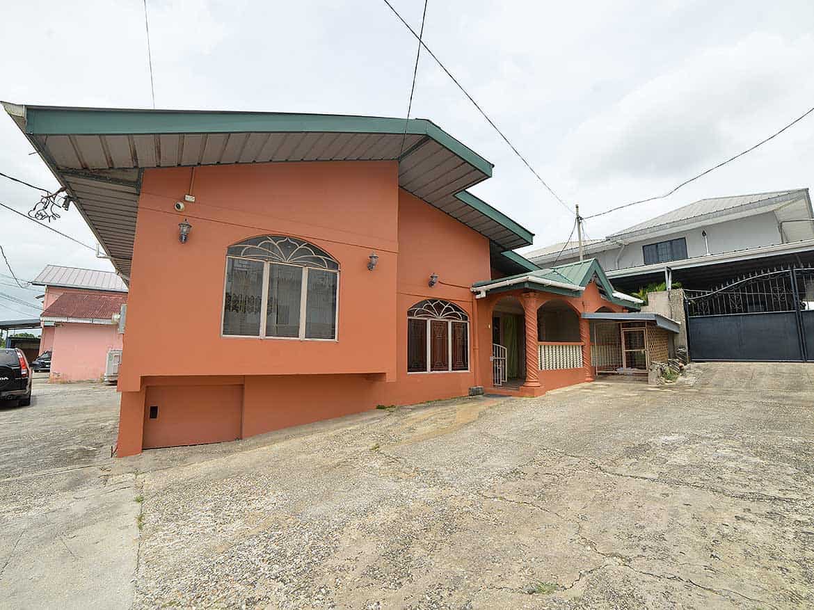 Cornerstone™ Residential Home in Arima Cornerstone- Residential house on Cleaver Road, Arima with a peach exterior and green roof.