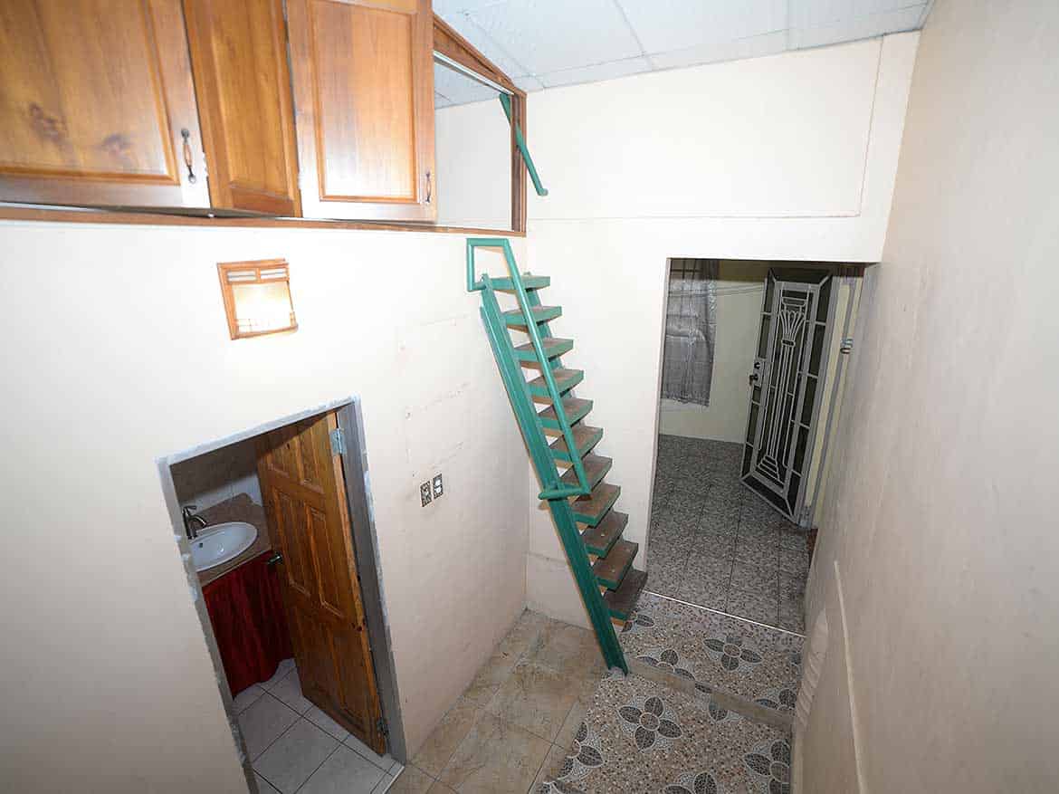 Interior of Cornerstone™ property in Arima Cornerstone- Staircase inside Cornerstone™ property in Arima with wooden cabinets.