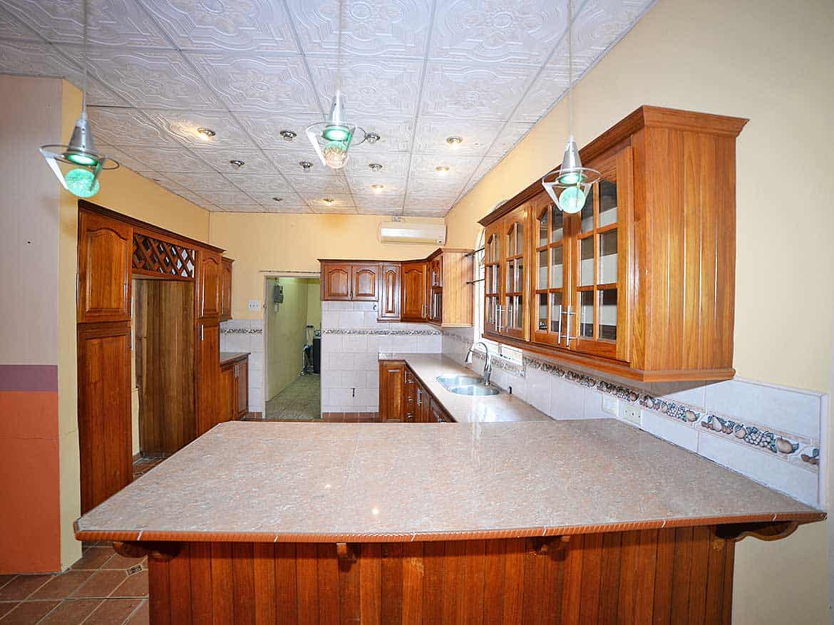 Cornerstone™ Kitchen in Arima Cornerstone- Spacious kitchen with wooden cabinets and a breakfast bar in Arima.