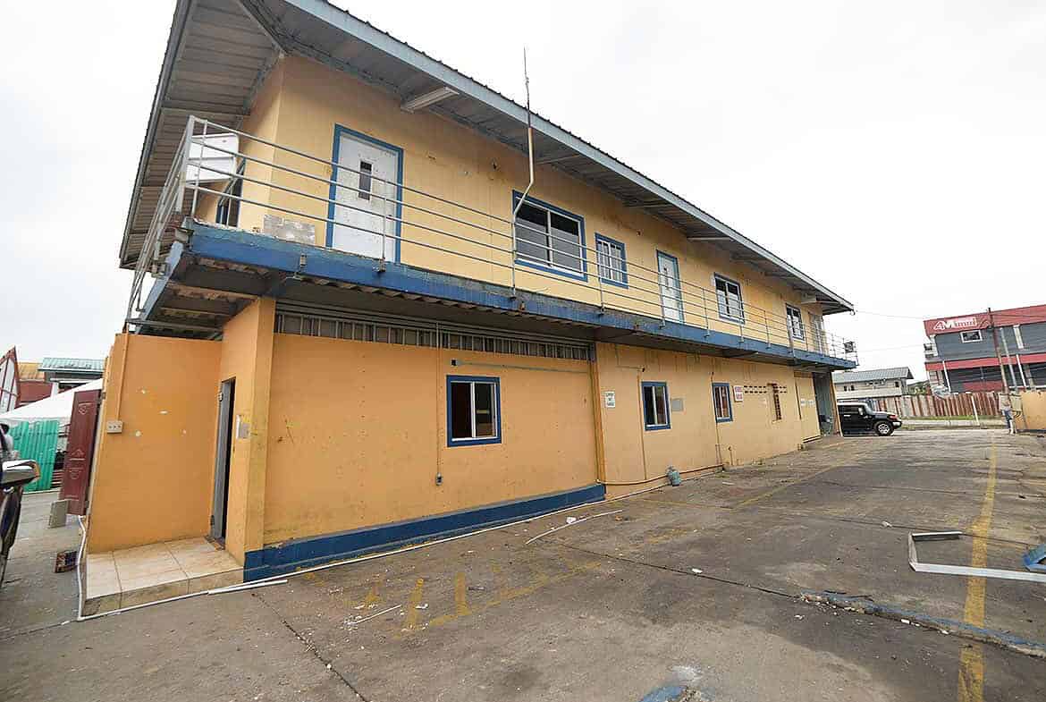 Cornerstone- Two-story Cornerstone™ building with yellow walls and blue accents on Johnny King Road.