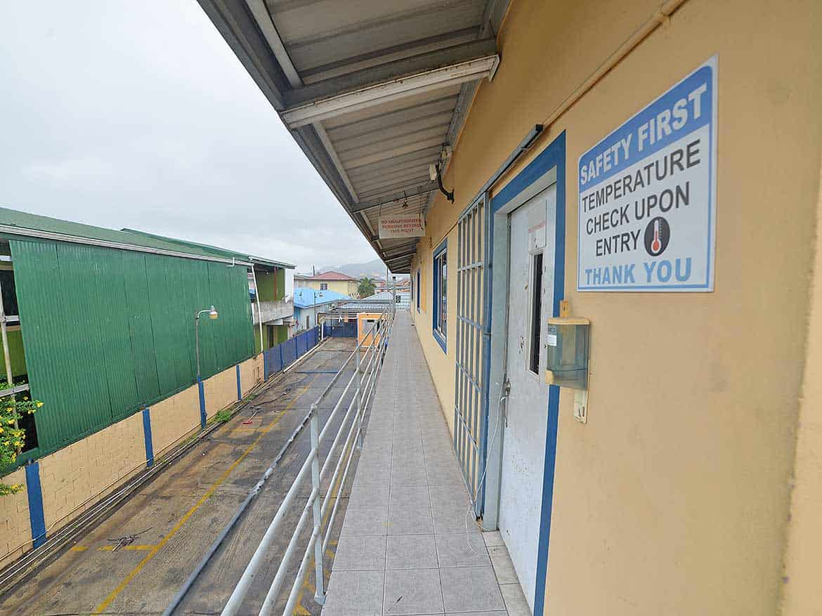 Cornerstone™ Building Entrance Cornerstone- Building entrance with safety sign and temperature check notice.