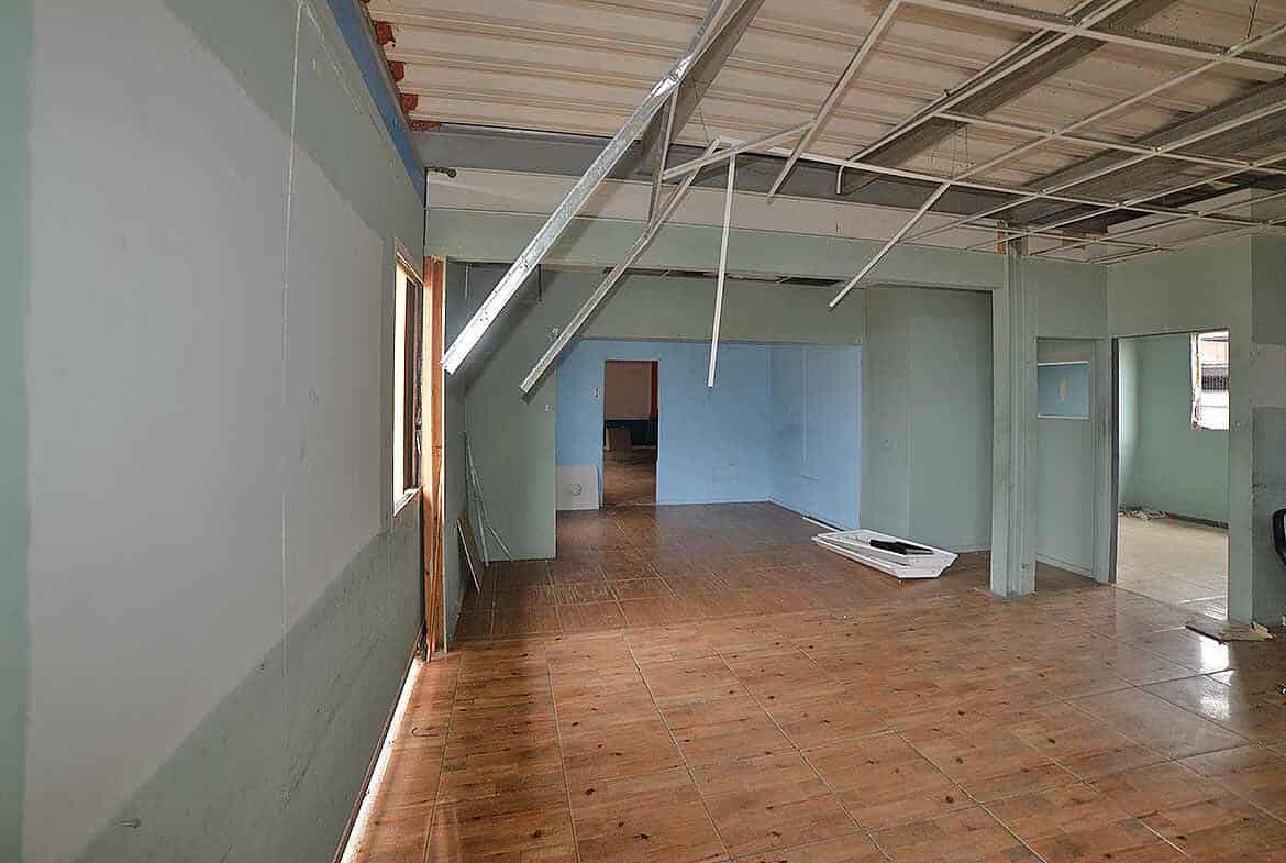 Cornerstone- Construction site with exposed ceiling and unfinished walls.