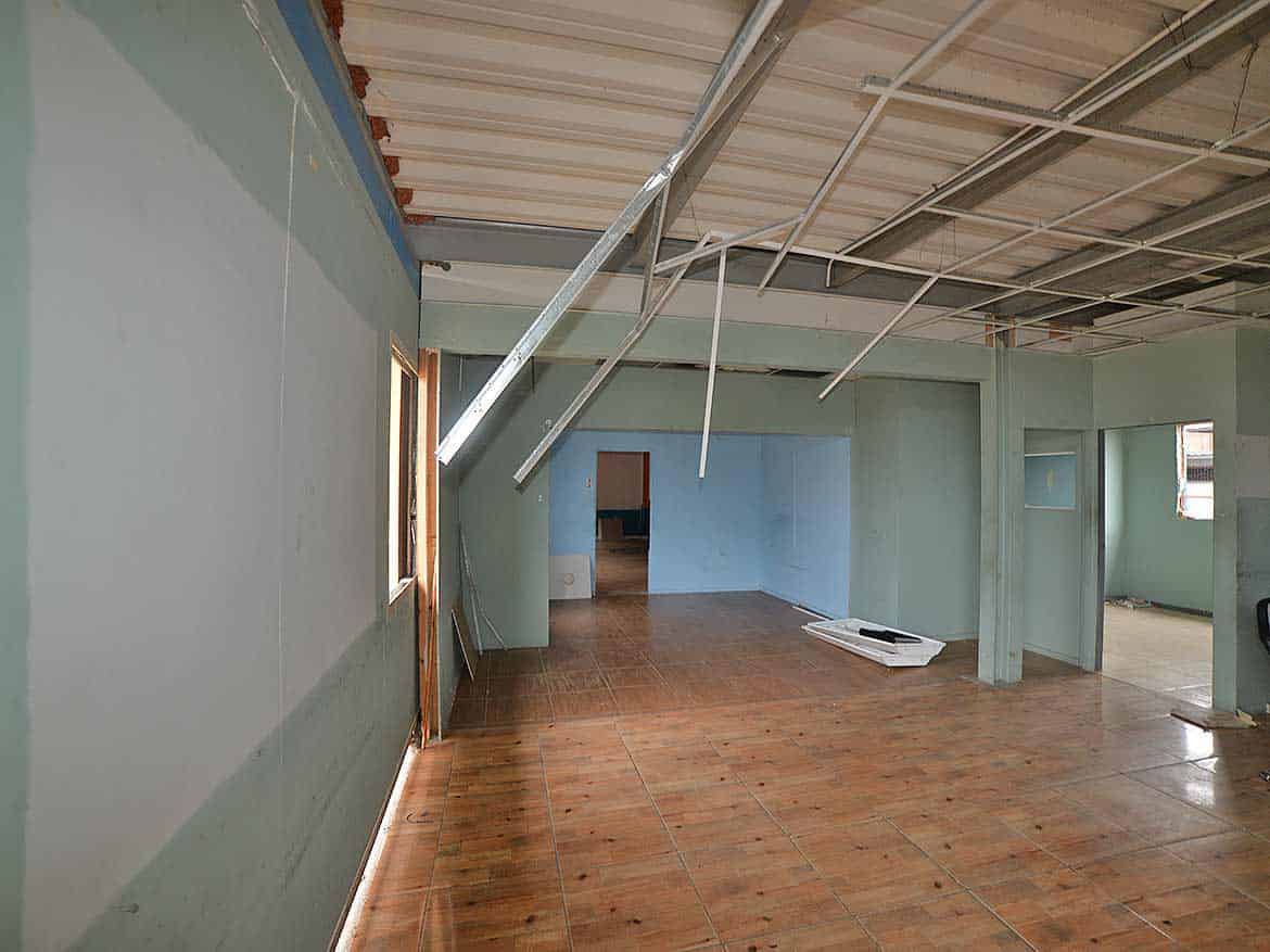 Interior of Under-Construction Building Cornerstone- Construction site with exposed ceiling and unfinished walls.