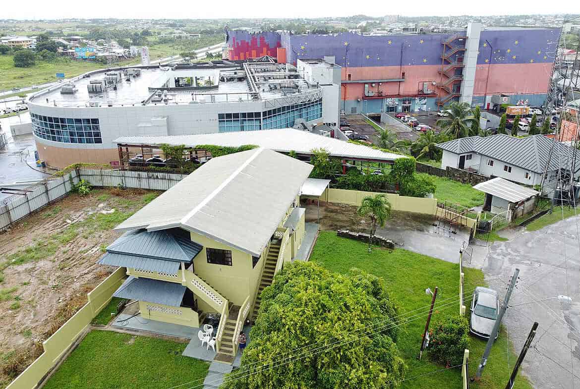 Cornerstone- Mixed residential and commercial buildings in Corinth with greenery and roads.