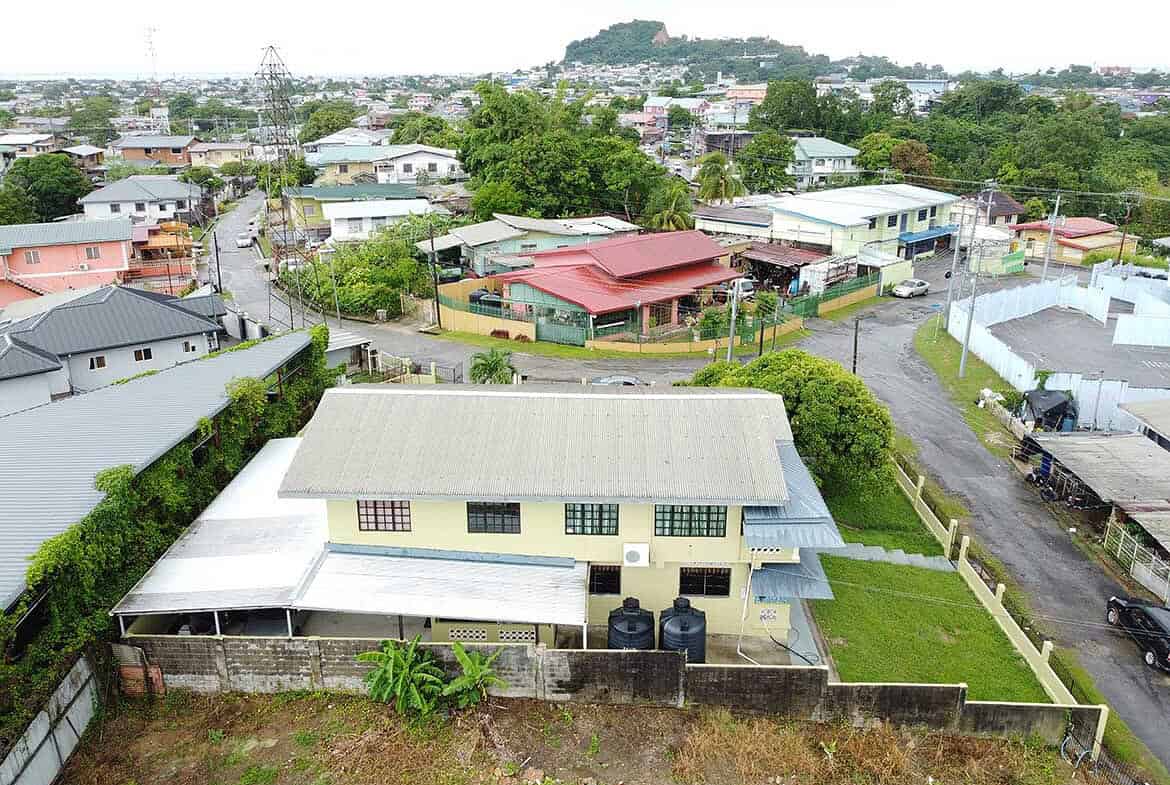 Cornerstone- Aerial view of houses on Braemar Road in Corinth with lush greenery and surrounding neighborhood.