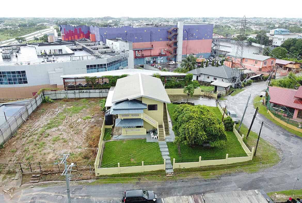 Cornerstone- Aerial view of a modern house on Braemar Road, Corinth with surrounding neighborhood and cityscape.