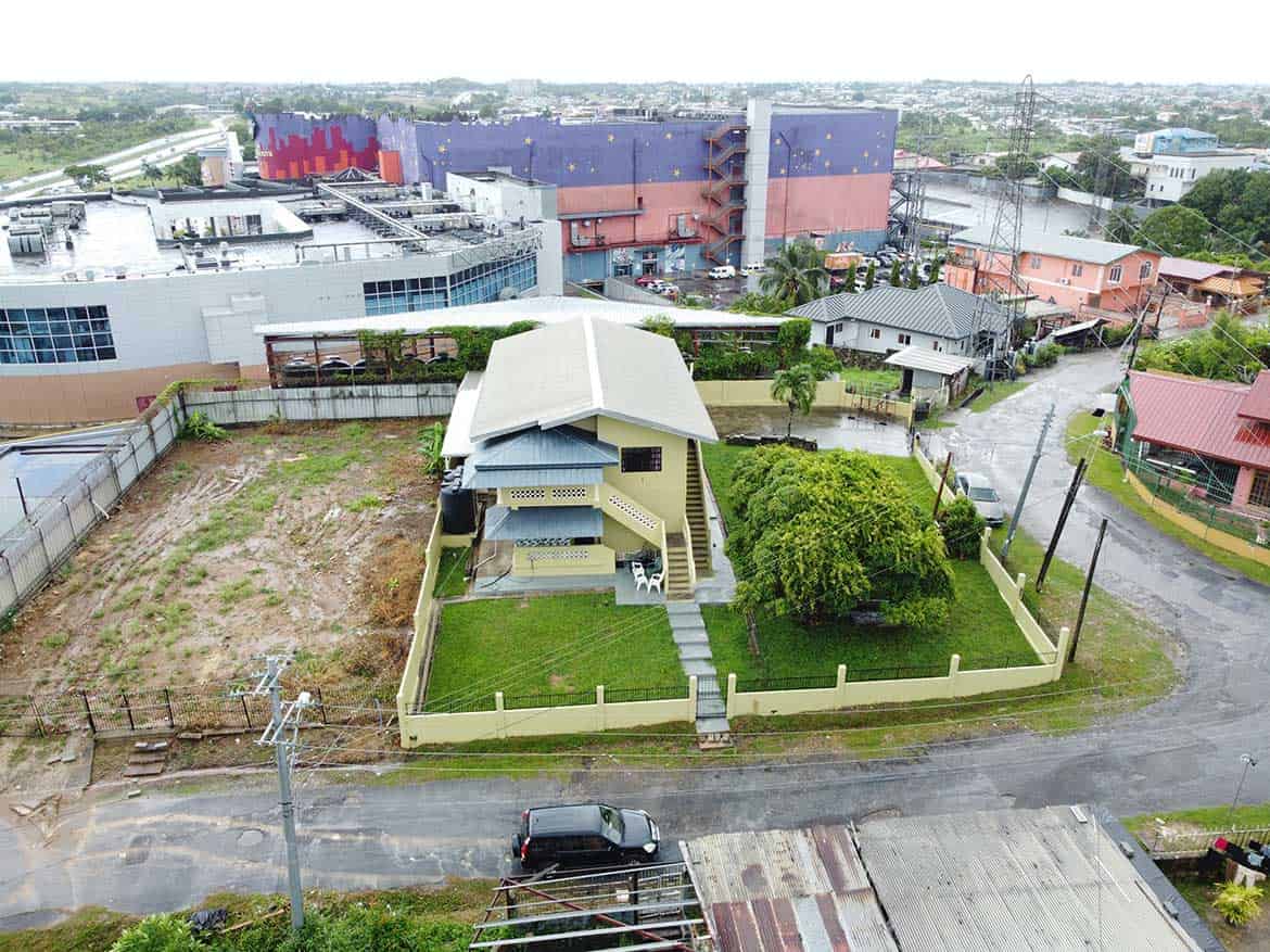 Cornerstone™ Residential Property in Corinth Cornerstone- Aerial view of a modern house on Braemar Road, Corinth with surrounding neighborhood and cityscape.