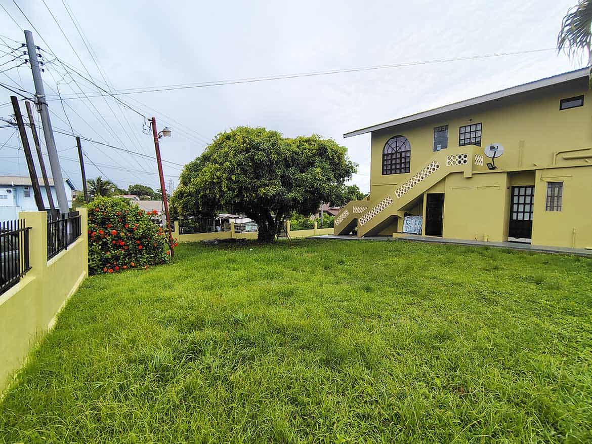 Residential Property on Braemar Road Cornerstone- Yellow house with stairs and lush green yard in Corinth.