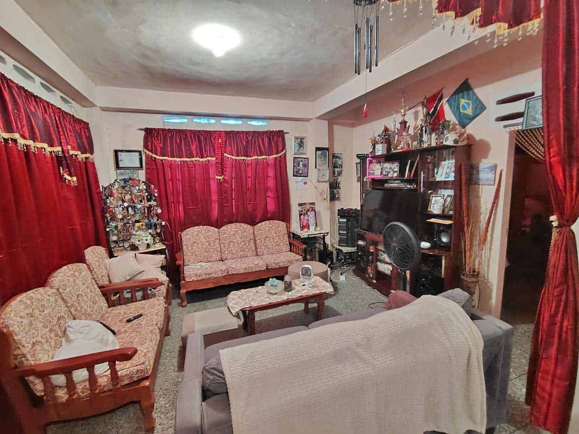 Cozy Living Room with Red Curtains Cornerstone- Living room with red curtains, vintage furniture, and entertainment center.