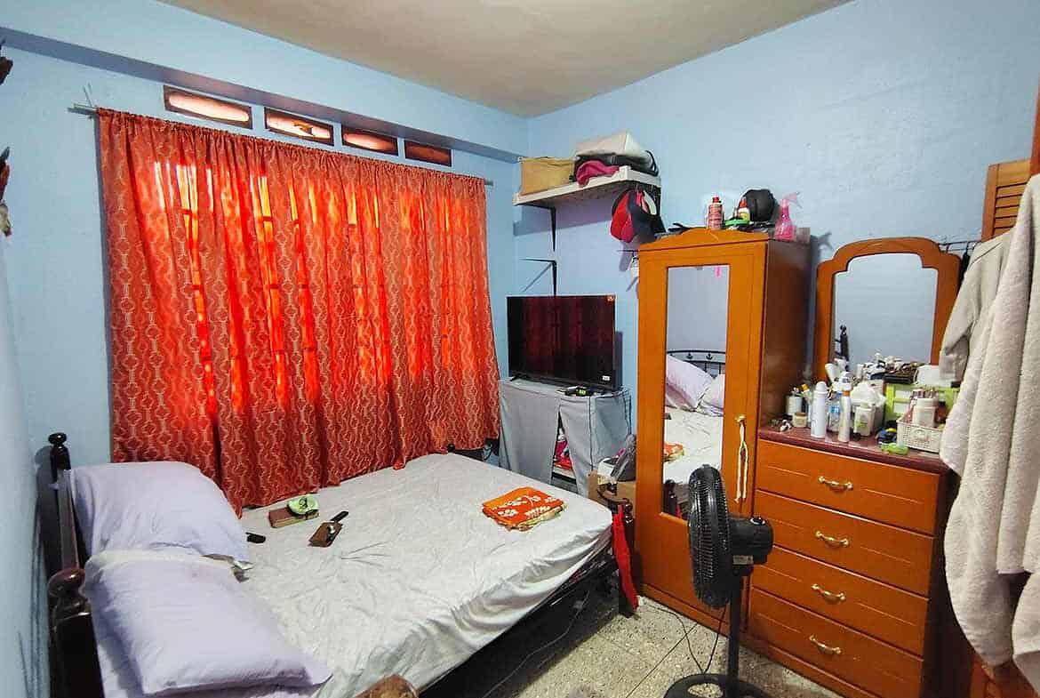 Cornerstone- Interior of a bedroom with a bed, dresser, and TV in Corinth.