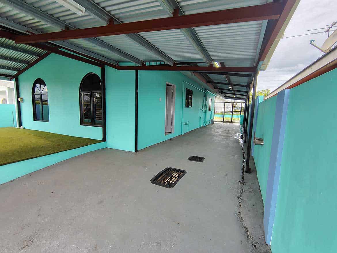 Cornerstone™ at Cashew Gardens, Edinburgh Cornerstone- Colorful building exterior at Cashew Gardens with covered walkway.