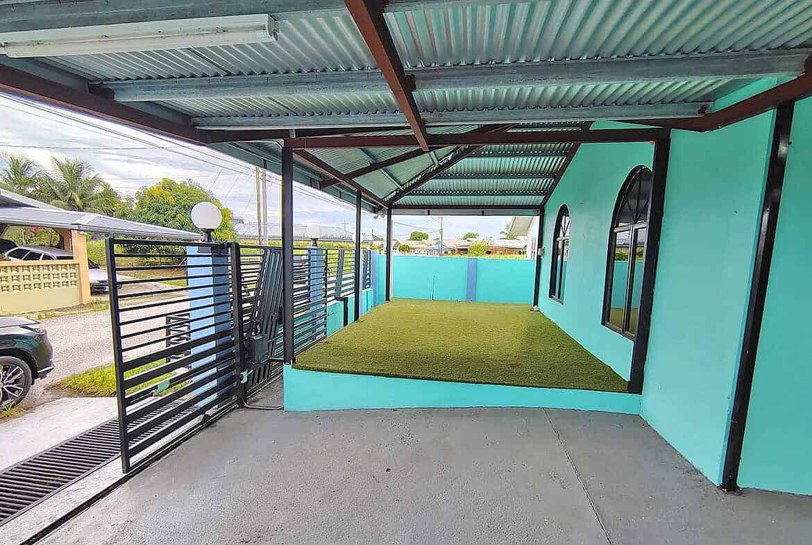 Cornerstone- Covered porch with artificial grass and turquoise walls at Cornerstone™.
