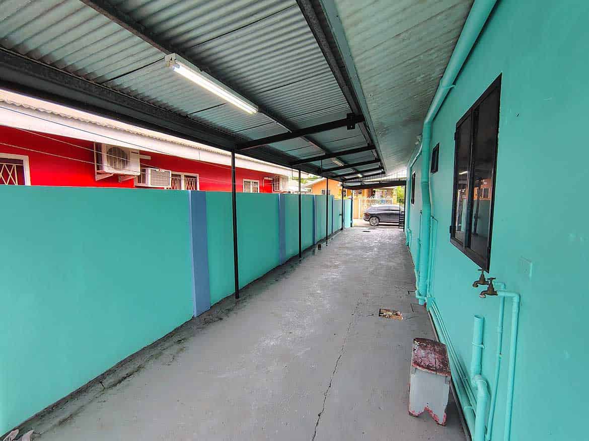 Colorful Building Exterior in Edinburgh Cornerstone- Vibrant turquoise building with a covered walkway in Edinburgh.